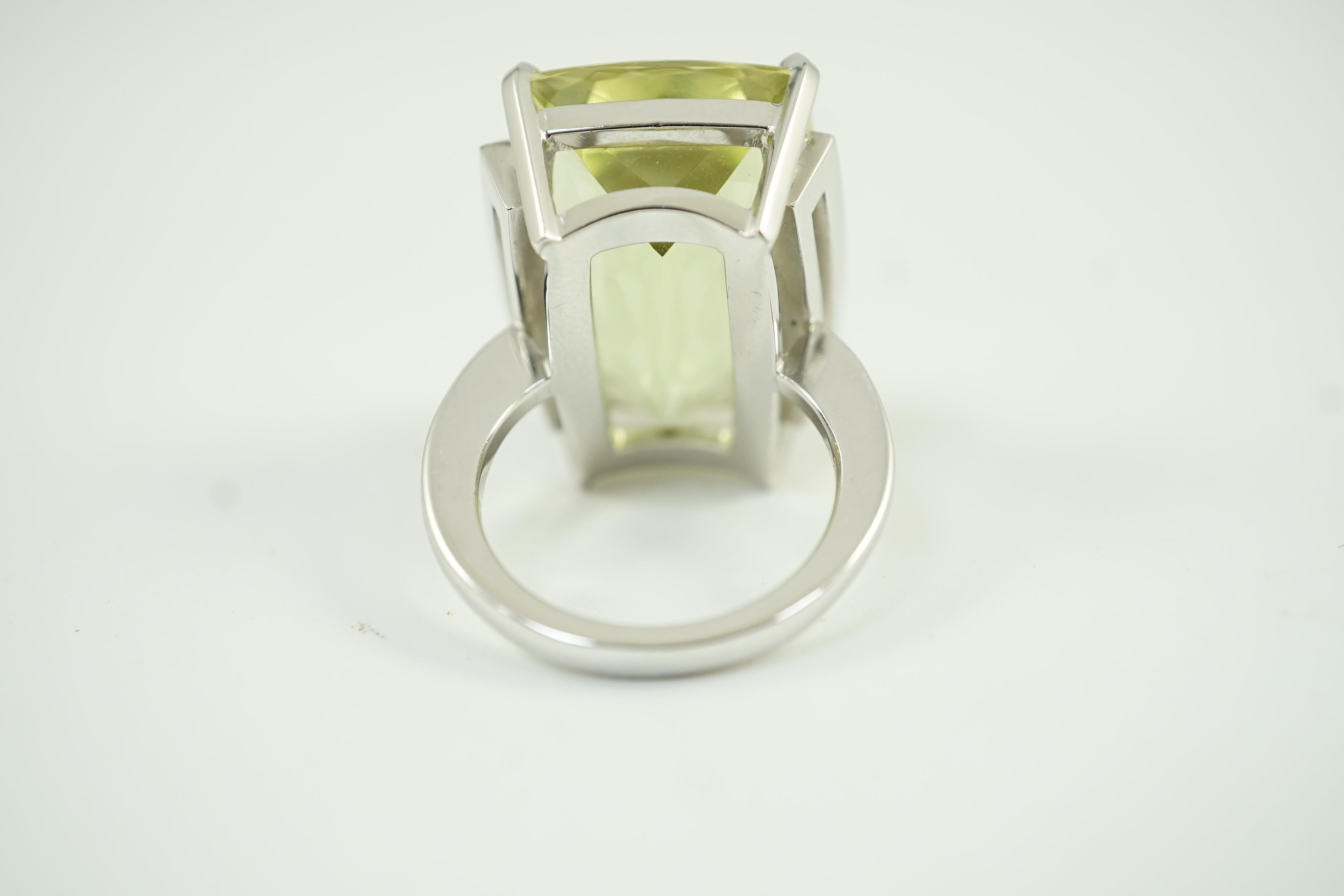 A modern white gold and shaped rectangular fancy cut pale green beryl set dress ring, with diamond chip setting